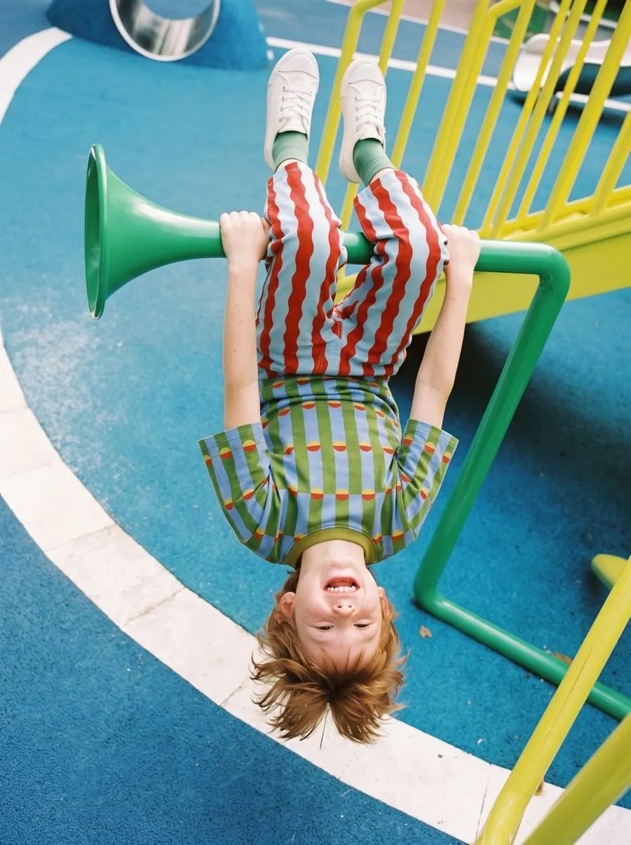 Outdoor scene of a child on a playground wearing the outfit
