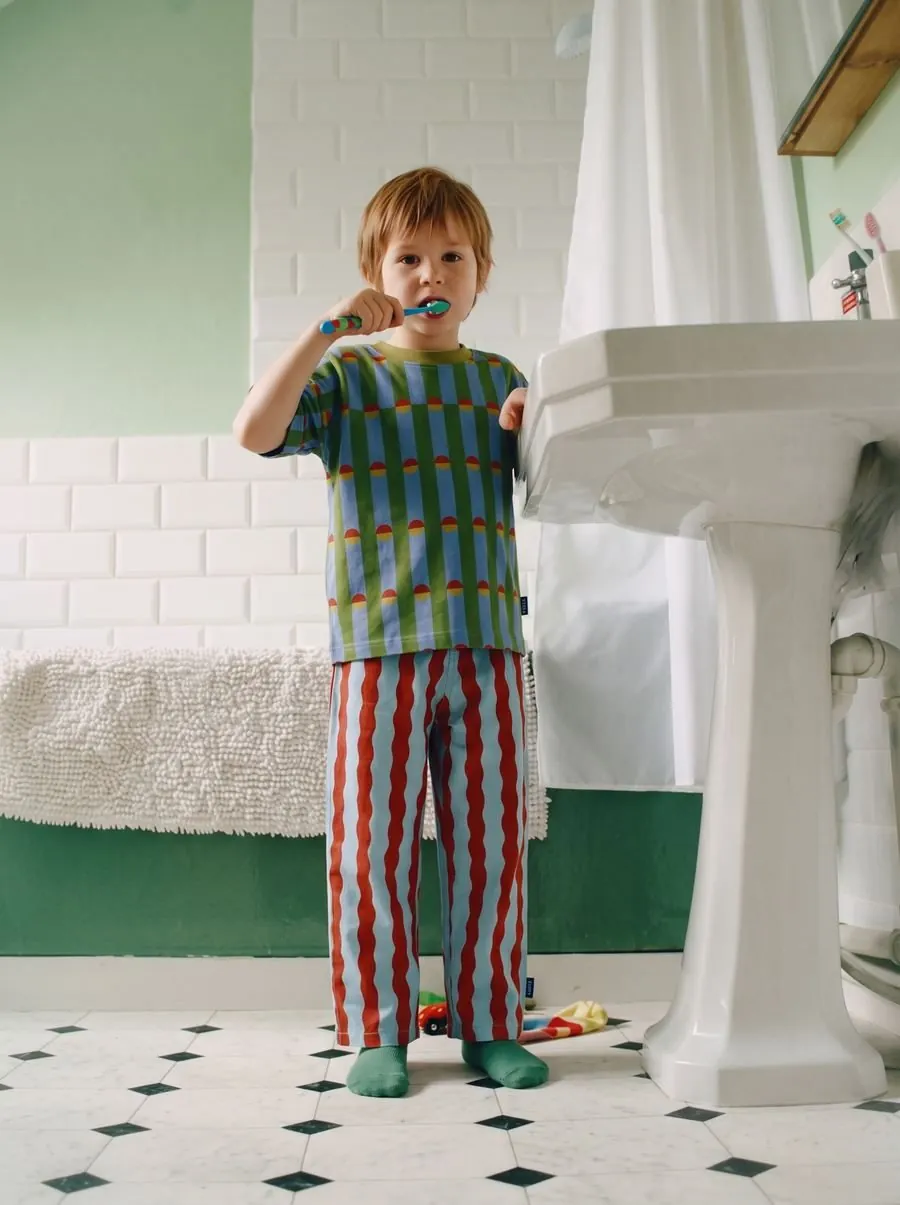 Lifestyle scene of a child wearing the outfit in a bathroom